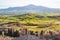 Tuscan valley with green hilly fields in sunset.