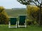 Tuscan view with two chairs in the foreground