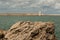 Tuscany Coastline: White Lighthouse Tower, Cliffs and Stone Jetty near Sea, Italy