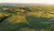 Tuscany countryside aerial landscape with fields, vineyards and roads at sunset