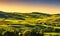 Tuscany countryside landscape panorama at sunset, rolling hills, fields, meadow. Italy