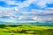 Tuscany, farmland and cypress trees, green fields. San Quirico O