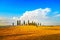 Tuscany, farmland, cypress trees and white road. Siena, Val d Or