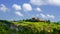 Tuscany landscape with green rolling hills in spring time ,agriculture crop  and farming house