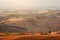 Tuscany landscape at sunrise. Tuscan farm house, vineyard, hills.