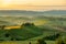 Tuscany landscape at sunrise. Typical for the region tuscan farm house, hills, vineyard. Italy