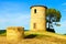 Tuscany, Maremma sunset landscape. Rural tower and tree on hill.