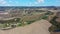 Tuscany rural landscape with house, cypress road and hills. Aerial view.