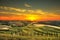 Tuscany, rural sunset landscape. Countryside farm, white road an