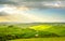 Tuscany, rural sunset landscape. Countryside farm, white road and cypress trees.