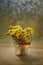 Tussilago bouquet in decorative bucket in water drops and sunshine