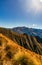 Tussock covered alpine slopes high in the mountain peaks at Isthmus Peak in Hawea New Zealand