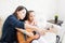 Tutor Showing Musical Notes To Girl Playing Guitar