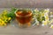 tutsan and camomile herbal tea in glass cup