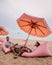 Tutu beach Pattaya Thailand, couple relax on the beach, men and woman on retro beach setting in Jomtien