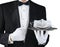 A tuxedo wearing waiter holding a silver tray With A COVID-19 mask. Horizontal format on white