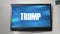 A TV displaying presidential message about Donald Trump
