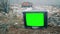 TV with green screen at the landfill site while snowing