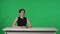 TV Live News Program: Female Presenter Reporting. Asian Anchorwoman Talks, Listens, Nods against the background of a