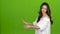 TV presenter tells everyone about the weather, she is smart and beautiful. Green screen