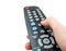 TV remote control in hand isolated closeup