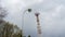 Tv tower with street lamp in the foreground. Lantern and high metal tower on dramatic sky background. Space for text