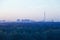 TV tower and urban houses in early blue dawn