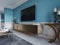 TV unit, TV set in a modern living room in a classic style with blue walls, black TV cabinet, console table with interior decor