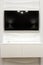 TV on the wall with a 3D panel. Laconic interior design.