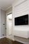 TV on the wall with a 3D panel. Laconic interior design.