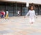 Tween African American girl skipping rope in schoolyard