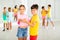 Tween boy and girl practicing slow pair dancing during group class