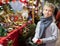 Tween boy looking for New Year decorations in street market
