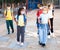 Tween boys and girls in protective masks going to school lessons