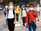 Tween boys and girls in protective masks going to school lessons