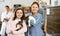 Tween girl with mother holding adopted kittens in animal shelter