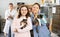 Tween girl with mother holding adopted kittens in animal shelter