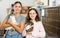 Tween girl with older sister holding adopted cats in animal shelter