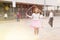 Tween girl in pink skirt jumping rope in schoolyard during recess