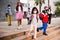 Tween schoolchildren in protective masks going to school lessons