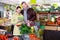 Tweenage girl with her father buying cauliflower in supermarket