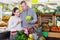 Tweenage girl with her father buying cauliflower in supermarket