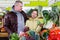 Tweenage girl with her father buying cauliflower in supermarket