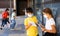 Tweenage schoolchildren in masks talking near school building