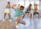 Tweenager dancing krump with group of children in dance studio