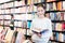 tweenager girl reading interesting book in bookstore