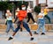 Tweens in protective masks dancing hip-hop on summer street