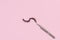 Tweezers hold false eyelashes on a pink pastel background. The concept of applying makeup. Copyspace, no one
