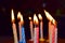 Twelve colorful lighted birthday candles