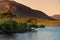 Twelve Pines Island, standing on a gorgeous background formed by the sharp peaks of a mountain range called Twelve Bens, County Ga